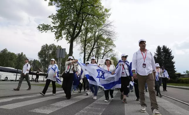 People attend the "March of the Living", the annual Holocaust remembrance event in memory of the six million Holocaust victims, at the former Nazi German death camp of Auschwitz-Birkenau in Oswiecim, Poland, Thursday, April 24, 2025. (AP Photo/Czarek Sokolowski)