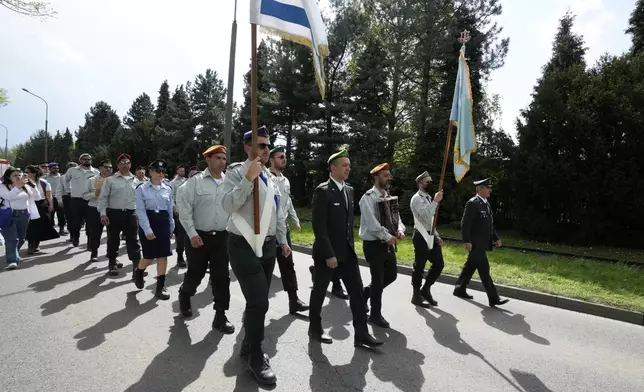 People attend the "March of the Living", the annual Holocaust remembrance event in memory of the six million Holocaust victims, at the former Nazi German death camp of Auschwitz-Birkenau in Oswiecim, Poland, Thursday, April 24, 2025. (AP Photo/Czarek Sokolowski)