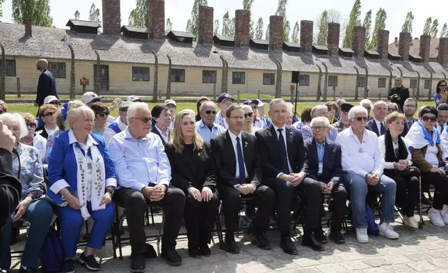Poland's President Andrzej Duda, center right, and his Israel's counterpart Isaac Herzog, center left, meet with holocaust survivors at the former Nazi German death camp of Auschwitz-Birkenau before the "March of the Living", the annual Holocaust remembrance event in memory of the six million Holocaust victims in Oswiecim, Poland, Thursday, April 24, 2025. (AP Photo/Czarek Sokolowski)