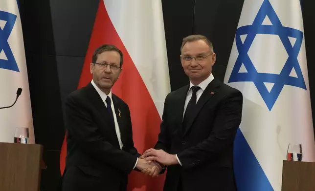 Poland's President Andrzej Duda shake hands with his Israel's counterpart Isaac Herzog as they meet in Oswiecim, Poland, Thursday, April 24, 2025. (AP Photo/Czarek Sokolowski)