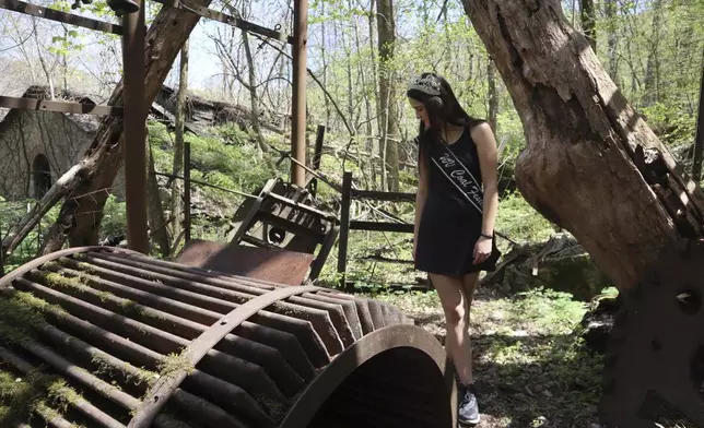 West Virginia Coal Festival teen beauty pageant winner Ava Johnson, 16, explores the ruins of the former Kay Moor coal town and camp in the New River Gorge National Park and Preserve near Fayetteville, W.Va., Thursday, April 17, 2025, (AP Photo/Leah Willingham)