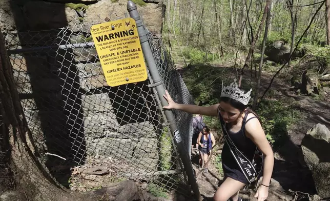 West Virginia Coal Festival teen beauty pageant winner Ava Johnson, 16, explores the abandoned Kay Moor mine complex in the New River Gorge National Park and Preserve near Fayetteville, W.Va., Thursday, April 17, 2025, (AP Photo/Leah Willingham)