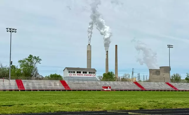 American Electric Power's John Amos coal-fired plant in Winfield, W.Va, is seen from Poca High School across the Kanawha River in Poca, W.Va., Tuesday, April 22, 2025. (AP Photo/John Raby)