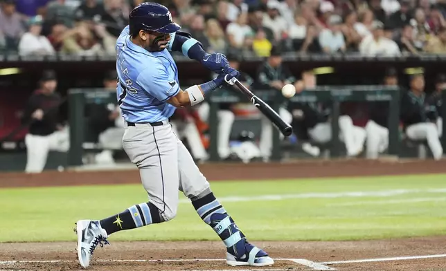 Tampa Bay Rays' José Caballero connects for a run-scoring single against the Arizona Diamondbacks during the second inning of a baseball game Wednesday, April 23, 2025, in Phoenix. (AP Photo/Ross D. Franklin)