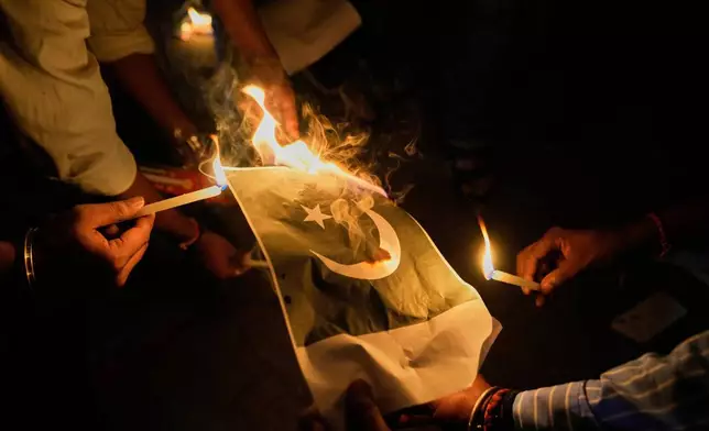 People burn Pakistani flags during a protest against the killing of tourists by militants near Pahalgam in Indian controlled Kashmir, in Guwahati, India, Thursday, April 24, 2025. (AP Photo/Anupam Nath)