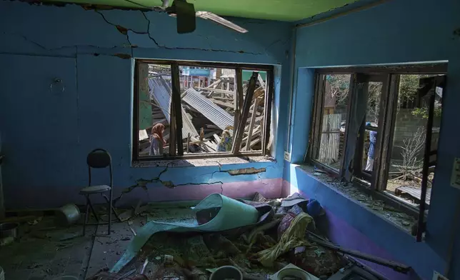 Kashmiri women inspect the blown-up family home of Asif Shiekh, a militant who officials say is involved in the deadly attack on tourists in Pahalgam, at Monghama village in Tral, south of Srinagar, Indian controlled Kashmir, Friday, April 25, 2025. (AP Photo/Dar Yasin)
