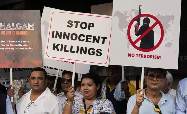 Members of airlines and tourism facility providers walk with posters during a protest against the killing of tourists by militants near Pahalgam in Indian controlled Kashmir, in Kolkata, India, Thursday, April 24, 2025. (AP Photo/Bikas Das)