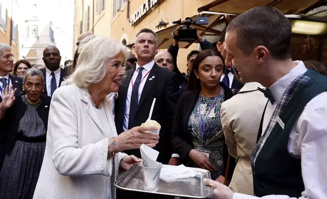 Britain's Queen Camilla holds an ice cream in Rome, Wednesday, April 9, 2025. (Vincenzo Livieri, Pool Photo via AP)