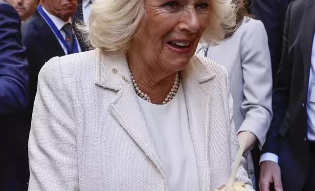 Britain's Queen Camilla holds an ice cream in Rome, Wednesday, April 9, 2025. (Vincenzo Livieri, Pool Photo via AP)