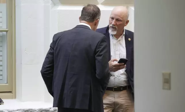 Rep. Chip Roy, R-Texas, right, and Rep. Scott Perry, R-Pa., members of the conservative House Freedom Caucus, meet outside of the closed-door House Republican Conference as Speaker of the House Mike Johnson, R-La., talks to fellow Republicans to push for a House-Senate compromise budget resolution to advance President Donald Trump's agenda, at the Capitol in Washington, Tuesday, April 8, 2025. (AP Photo/J. Scott Applewhite)