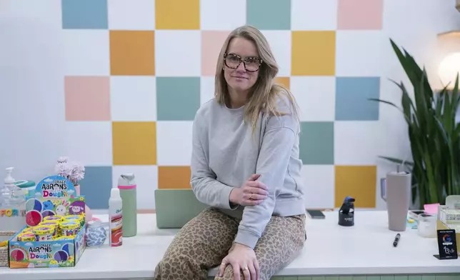 Elizabeth Mahon, owner of the baby store Three Littles, poses for a photo at her Union Market location in Washington, on Wednesday, April 16, 2025. (AP Photo/Nathan Howard)