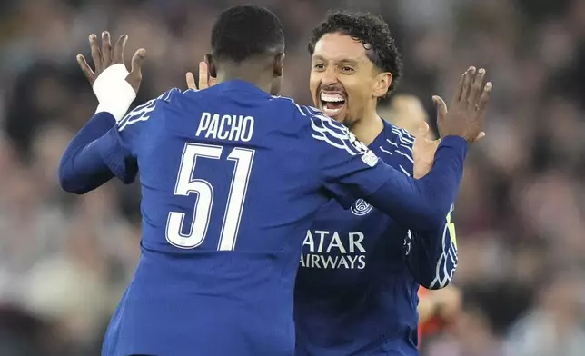 PSG's Marquinhos celebrates with PSG's Willian Pacho at the end of the Champions League quarterfinal second leg soccer match between Aston Villa and Paris Saint-Germain at the Villa Park stadium, in Birmingham, England, Tuesday, April 15, 2025. (AP Photo/Frank Augstein)