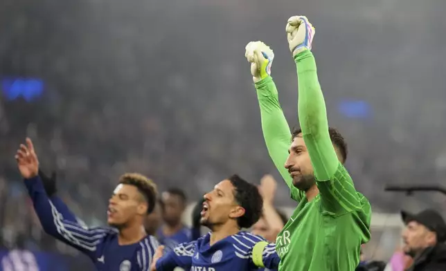PSG's goalkeeper Gianluigi Donnarumma and team mates applaud fans at the end of the Champions League quarterfinal second leg soccer match between Aston Villa and Paris Saint-Germain at the Villa Park stadium, in Birmingham, England, Tuesday, April 15, 2025. (AP Photo/Frank Augstein)