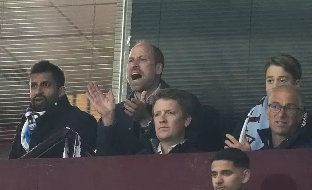 Britain's Prince William, centre, and Prince George, top right, support Aston Villa during the Champions League quarterfinal second leg soccer match between Aston Villa and Paris Saint-Germain at the Villa Park stadium, in Birmingham, England, Tuesday, April 15, 2025. (Nick Potts/PA via AP)