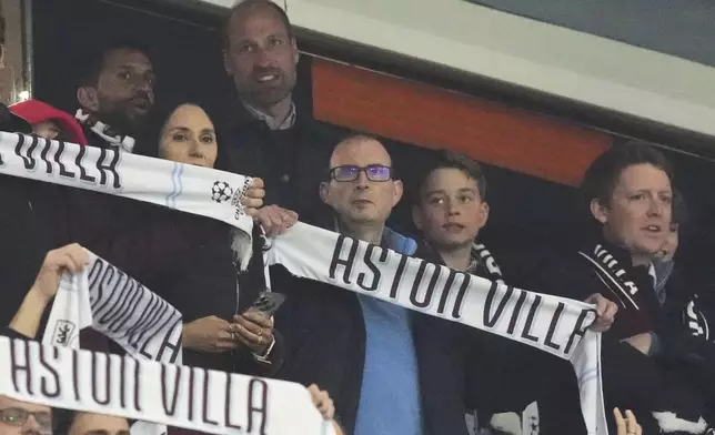Britain's Prince William and Prince George attend the Champions League quarterfinal second leg soccer match between Aston Villa and Paris Saint-Germain at the Villa Park stadium, in Birmingham, England, Tuesday, April 15, 2025. (AP Photo/Frank Augstein)