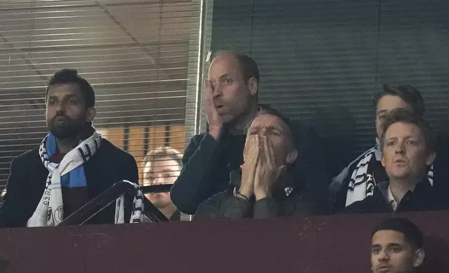 CORRECTS PHOTOGRAPHER'S NAME - Britain's Prince William, centre top, reacts during the Champions League quarterfinal second leg soccer match between Aston Villa and Paris Saint-Germain at the Villa Park stadium, in Birmingham, England, Tuesday, April 15, 2025. (Nick Potts/PA via AP)
