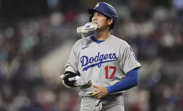 Los Angeles Dodgers' Shohei Ohtani walks to the dugout after grounding out to first in the fifth inning of a baseball game against the Texas Rangers in Arlington, Texas, Sunday, April 20, 2025. (AP Photo/Tony Gutierrez)