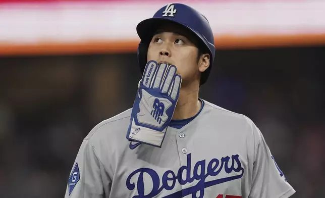 Los Angeles Dodgers' Shohei Ohtani walks off the field and to the dugout after a Teoscar Hernandez fly out in the eighth inning of a baseball game against the Texas Rangers in Arlington, Texas, Sunday, April 20, 2025. (AP Photo/Tony Gutierrez)