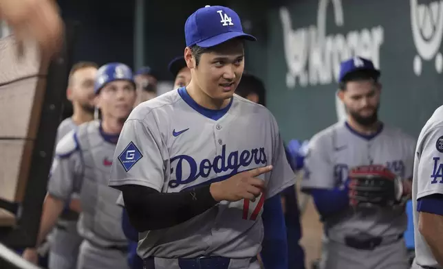 Los Angeles Dodgers' Shohei Ohtani celebrates the team's win following a baseball game against the Texas Rangers in Arlington, Texas, Sunday, April 20, 2025. (AP Photo/Tony Gutierrez)