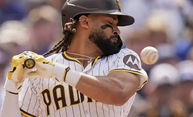 San Diego Padres' Fernando Tatis Jr. moves away from an inside pitch while batting during the seventh inning of a baseball game against the Chicago Cubs Wednesday, April 16, 2025, in San Diego. (AP Photo/Gregory Bull)
