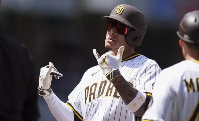 San Diego Padres' Manny Machado celebrates after hitting an RBI single during the third inning of a baseball game against the Chicago Cubs Wednesday, April 16, 2025, in San Diego. (AP Photo/Gregory Bull)