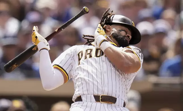 San Diego Padres' Fernando Tatis Jr. moves away from an inside pitch while batting during the seventh inning of a baseball game against the Chicago Cubs Wednesday, April 16, 2025, in San Diego. (AP Photo/Gregory Bull)