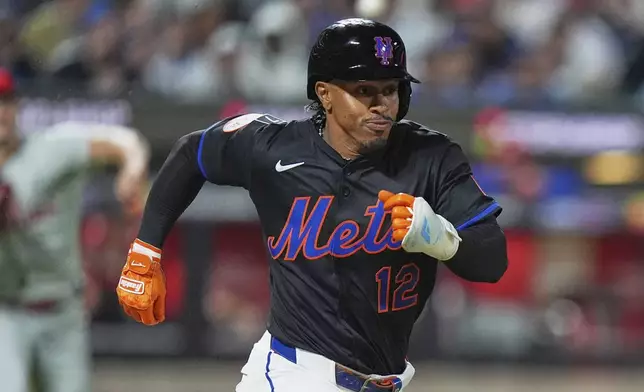 New York Mets' Francisco Lindor (12) beats a throw to first base by Philadelphia Phillies pitcher Tanner Banks for a single during the seventh inning of a baseball game Tuesday, April 22, 2025, in New York. (AP Photo/Frank Franklin II)