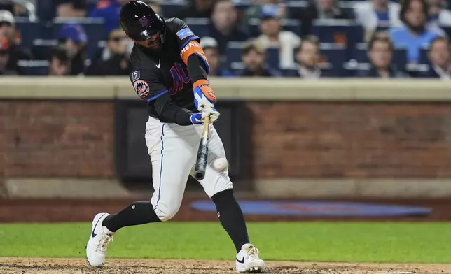 New York Mets' Luis Torrens hits a two-run single during the seventh inning of a baseball game against the Philadelphia Phillies Tuesday, April 22, 2025, in New York. (AP Photo/Frank Franklin II)
