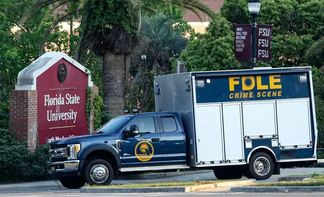 Crime scene vehicle at the Woodward Avenue entrance to the Florida State University campus after a shooting, in Tallahassee, Fla., Thursday, April 17, 2025. (AP Photo/Gary McCullough)