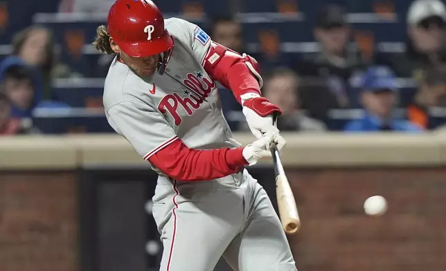 Philadelphia Phillies' Alec Bohm hits a single during the ninth inning of a baseball game against the New York Mets Monday, April 21, 2025, in New York. (AP Photo/Frank Franklin II)