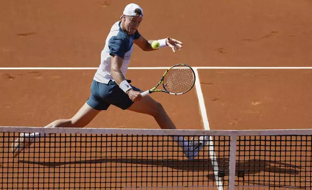 Denmark's Holger Rune returns to Spain's Carlos Alcaraz during the ATP Barcelona Open tennis final in Barcelona, Spain, Sunday, April 20, 2025. AP Photo/Joan Monfort)