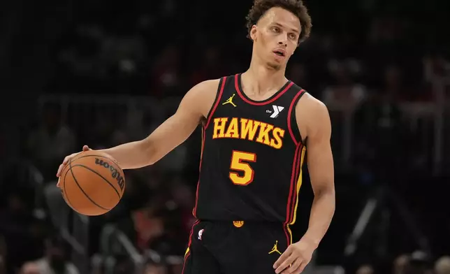 Atlanta Hawks guard Dyson Daniels (5) dribbles in the first half of an NBA play-in tournament basketball game against the Miami Heat, Friday, April 18, 2025, in Atlanta. (AP Photo/Brynn Anderson)