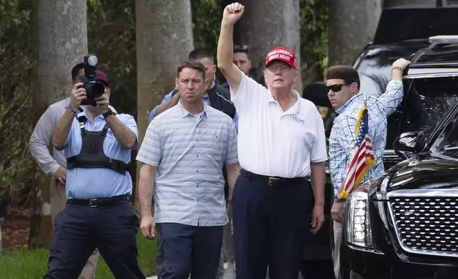 President Donald Trump gestures to supporters gathered for a Presidents Day rally as he leaves the Trump International Golf Club, Monday, Feb. 17, 2025, in West Palm Beach, Fla. (AP Photo/Ben Curtis)