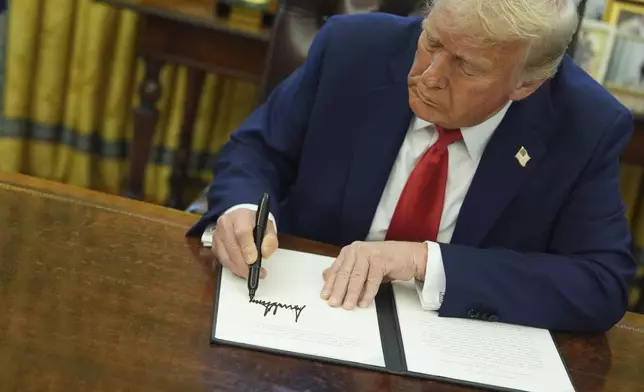 President Donald Trump signs an executive order in the Oval Office of the White House, Monday, Feb. 3, 2025, in Washington. (AP Photo/Evan Vucci)