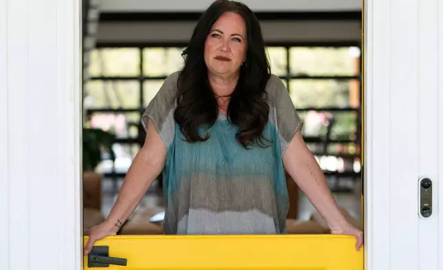 Erika Wright, a mother whose two school-age children attend a rural school district in Cleveland County poses for a portrait at her home in Noble, Okla., on Tuesday, April 15, 2025. (AP Photo/Nick Oxford)