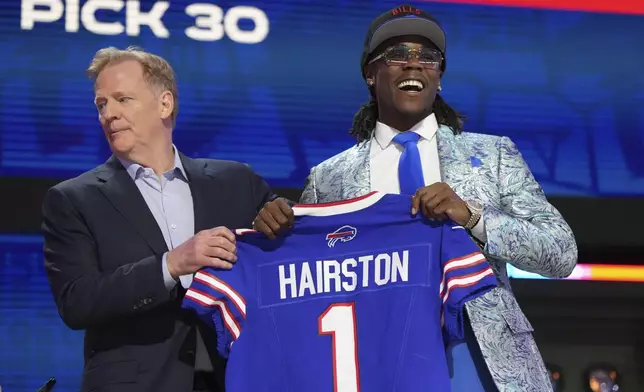 Kentucky cornerback Maxwell Hairston, right, poses NFL Commissioner Roger Goodell after being chosen by the Buffalo Bills with the 30th overall pick during the first round of the NFL football draft, Thursday, April 24, 2025, in Green Bay, Wis. (AP Photo/Jeff Roberson)