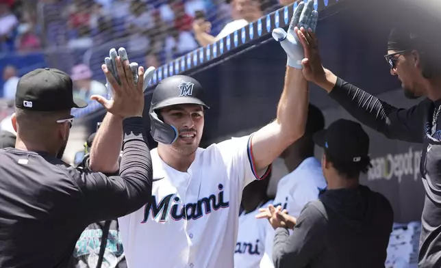 Miami Marlins' Matt Mervis is congratulated after hitting a two run home run during the first inning of a baseball game against the Cincinnati Reds, Wednesday, April 23, 2025, in Miami. (AP Photo/Lynne Sladky)