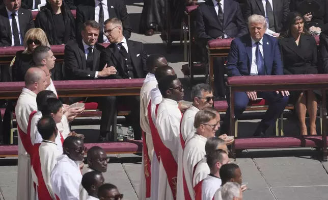 President Donald Trump, second right, with first lady Melania Trump, right, French President Emmanuel Macron, front row left, with Brigitte Macron, left, and Finland's President Alexander Stubb, third left, attend the funeral of Pope Francis in St. Peter's Square at the Vatican, Saturday, April 26, 2025. (AP Photo/Evan Vucci)