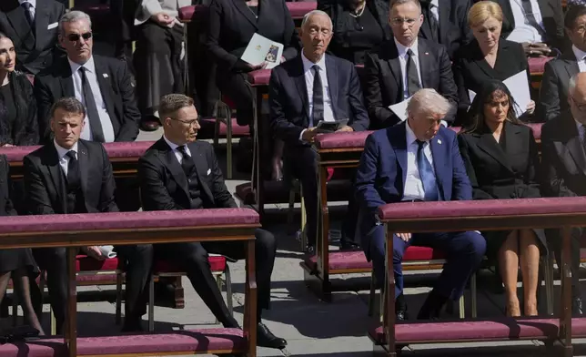 President Donald Trump, third from right, flanked by first lady Melania Trump, French President Emmanuel Macron, front row left, and Finland's President Alexander Stubb, second left, attend the funeral of Pope Francis in St. Peter's Square at the Vatican, Saturday, April 26, 2025. (AP Photo/Gregorio Borgia)