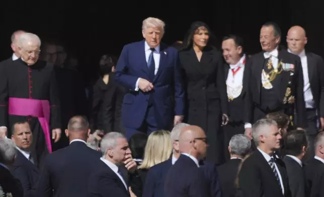 President Donald Trump and first lady Melania Trump, center, and other guests arrive, for the funeral of Pope Francis in St. Peter's Square at the Vatican, Saturday, April 26, 2025. (AP Photo/Andrew Medichini)