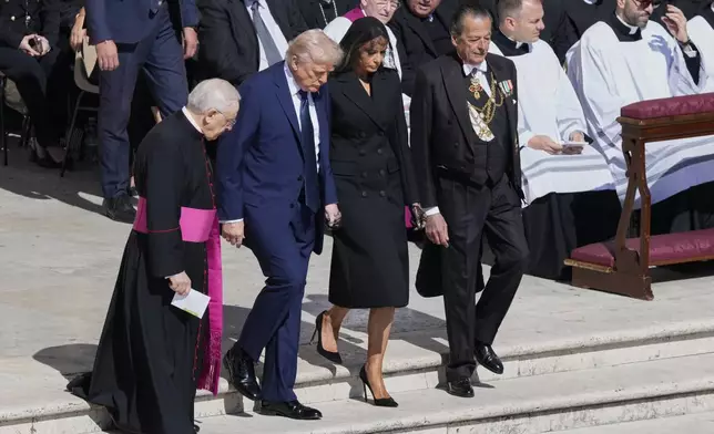 President Donald Trump and first lady Melania Trump, center, arrive for the funeral of Pope Francis in St. Peter's Square at the Vatican, Saturday, April 26, 2025. (AP Photo/Gregorio Borgia)
