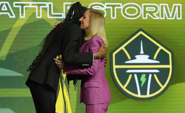 Dominique Malonga, left, embraces WNBA commissioner Cathy Engelbert after being selected second overall by the Seattle Storm during the first round of the WNBA basketball draft, Monday, April 14, 2025, in New York. (AP Photo/Pamela Smith)