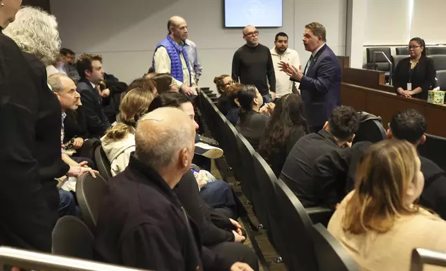 Lake County States Attorney Eric Rinehart speaks with family members and survivors during the sentencing hearing of Robert Crimo III at the Lake County Courthouse, in Waukegan, Ill., on Thursday, April 24, 2025. (Stacey Wescott/Chicago Tribune via AP, Pool)