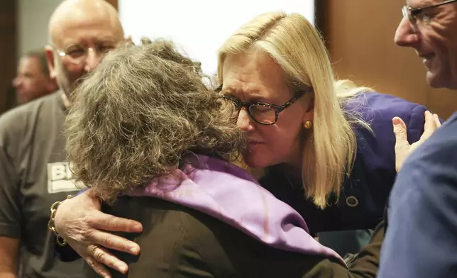 Highland Park Mayor Nancy Rotering hugs shooting survivor Erica Weeder during the sentencing hearing for Robert E. Crimo III at the Lake County Courthouse, in Waukegan, Ill., Thursday, April 24, 2025. (Stacey Wescott/Chicago Tribune via AP, Pool)