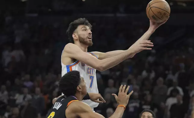 Oklahoma City Thunder forward Chet Holmgren (7) shoots over Phoenix Suns forward Ryan Dunn during the first half of an NBA basketball game, Wednesday, April 9, 2025, in Phoenix. (AP Photo/Rick Scuteri)