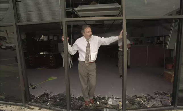 FILE - A man stands in the blown-out doorway of a downtown business a few blocks from the Alfred P. Murrah Federal Building, which was destroyed by a massive bomb, on April 19, 1995, in Oklahoma City. (AP Photo/Rick Bowmer, File)