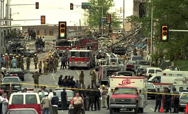 FILE - The streets surrounding the Alfred P. Murrah Federal Building in Oklahoma City are swamped with emergency vehicles and personnel on April 20, 1995, after a bomb tore through the building. (AP Photo/David J. Phillip, File)