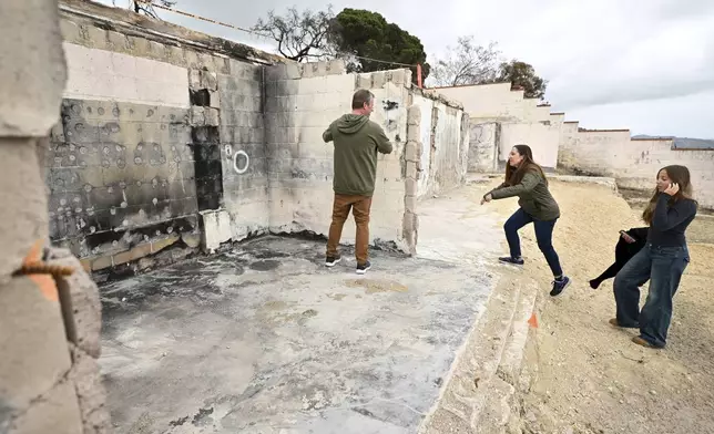 Keith and Rachel McNett along with daughter Teagan, right, visit there house that burned in the Mountain Fire Wednesday, April 16, 2025, in Camarillo, Calif. (AP Photo/Wally Skalij)