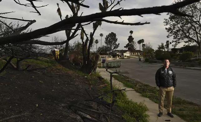 Supervisor Jeff Gorrell stands next to damage from the Mountain Fire along Old Coach Drive Wednesday, April 16, 2025, in Camarillo, Calif. (AP Photo/Wally Skalij)