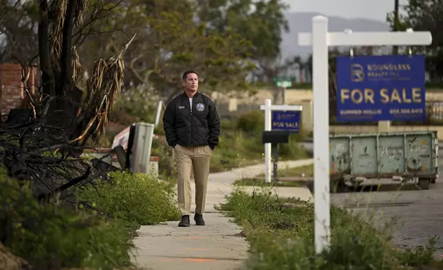 Supervisor Jeff Gorrell walks next to damage from the Mountain Fire along Old Coach Drive in Camarillo Wednesday, April 16, 2025, in Camarillo, Calif. (AP Photo/Wally Skalij)